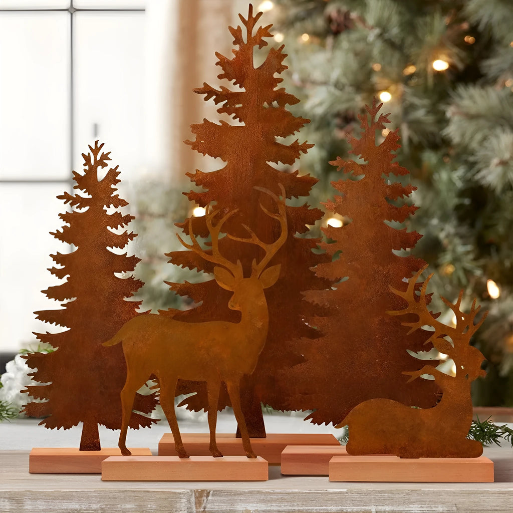 Three rusty metal Christmas decorations with elk and tree designs on white background