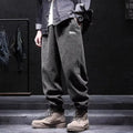 Grey men's casual sweatpants with ankle tie fastening and straight leg on a neutral background.