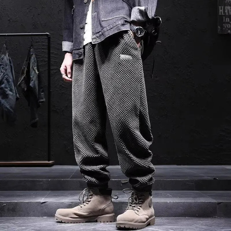 Grey men's casual sweatpants with ankle tie fastening and straight leg on a neutral background.