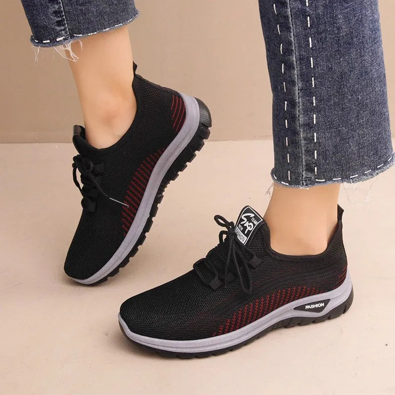 Women's breathable mesh lace-up sneakers with cross straps, round toe, and low heel in black, gray, and purple