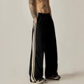 Black men's wide-leg climbing pants with a high waist and long straight-leg design on a neutral background.