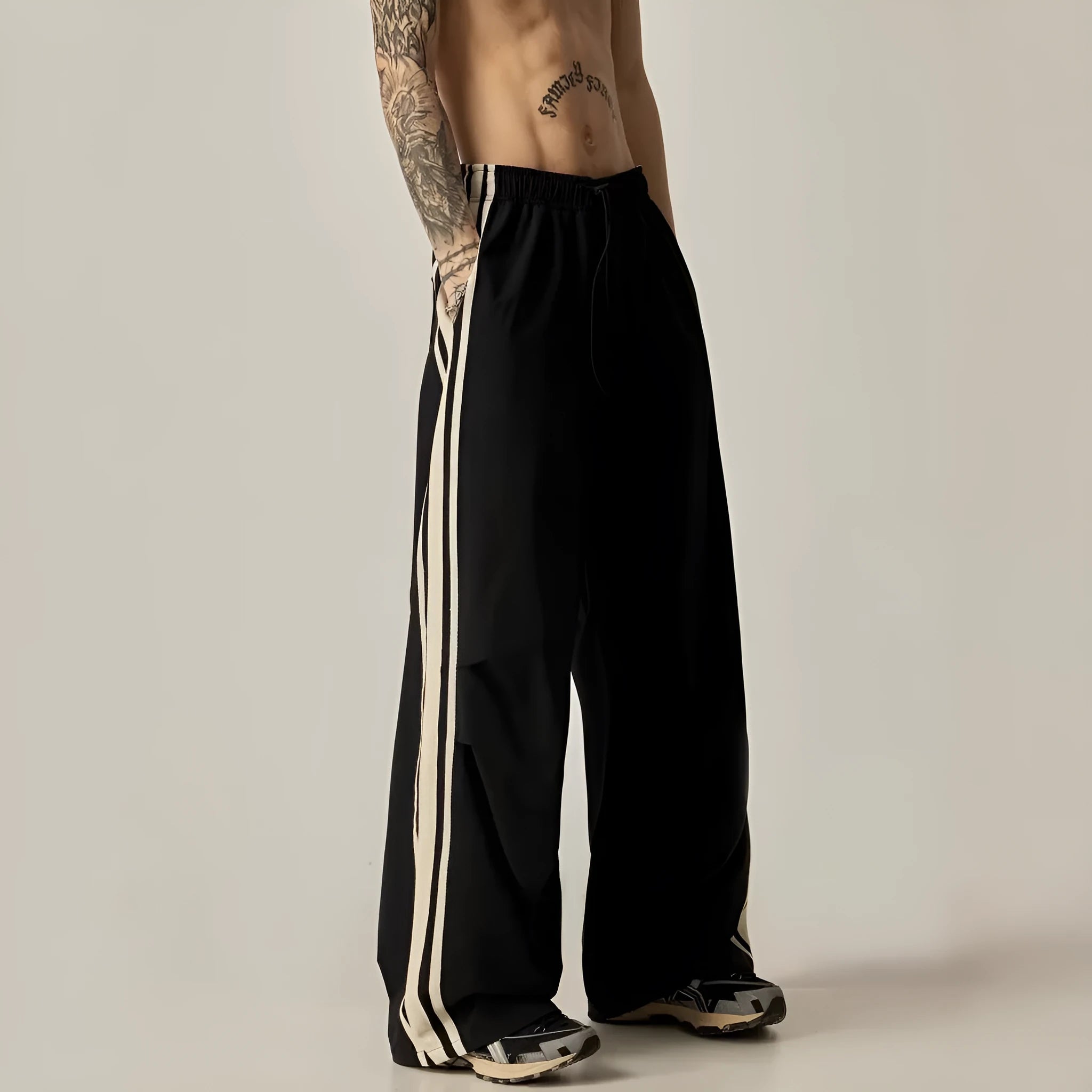 Black men's wide-leg climbing pants with a high waist and long straight-leg design on a neutral background.