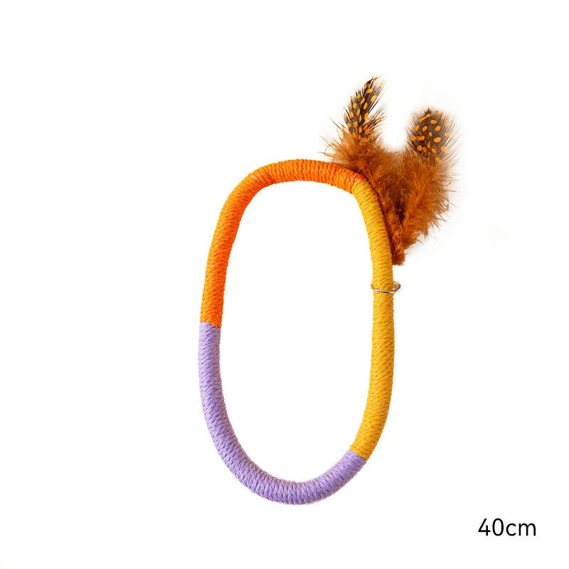 Green circular cotton rope cat toy with feathers and catnip for interactive feline play