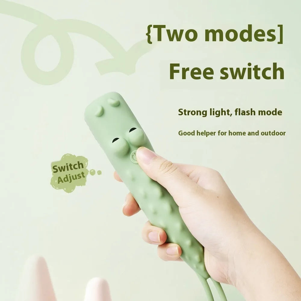 Four silicone animal toy flashlights in Blue Shark, Brown Lion, Brown Puppy, and Green Crocodile designs