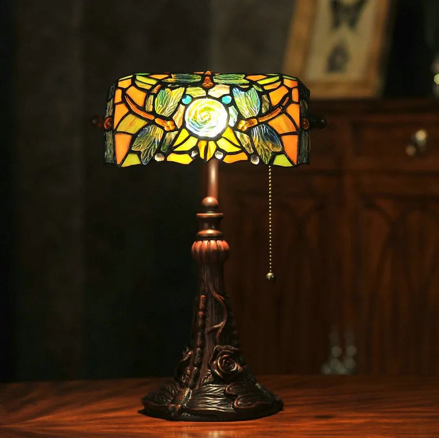 Tiffany table lamp with stained glass shade on resin base, 25cm wide by 36cm tall