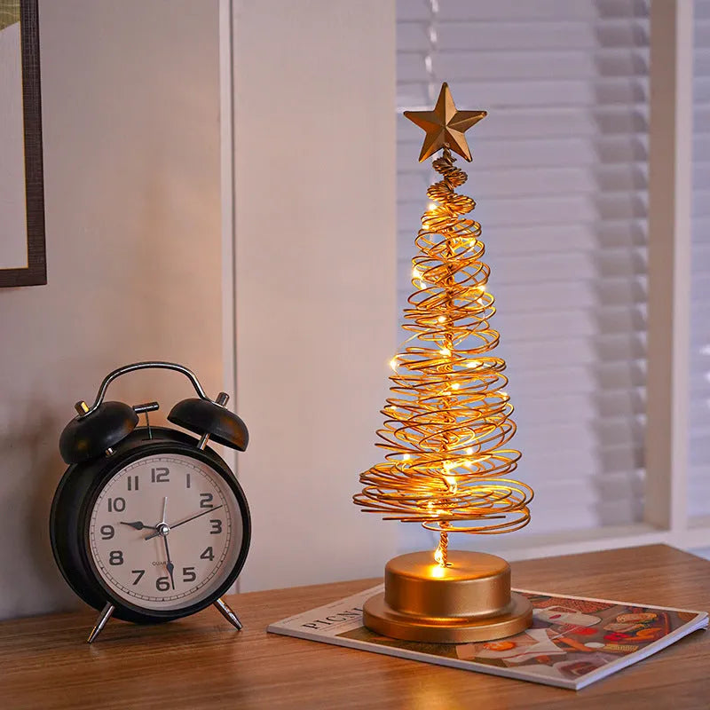 LED Christmas tree spiral light ornament in iron, golden finish, 33cm tall, warm white glow on a tabletop
