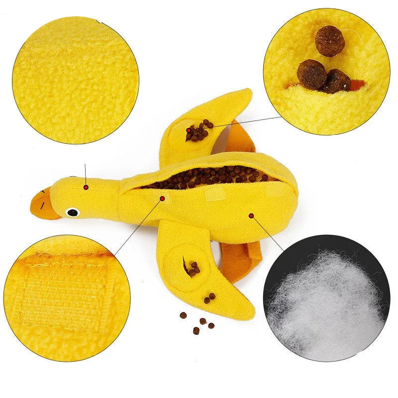 Yellow plush teddy dog toy with a attached duck doll and visible treat pockets on a white background.