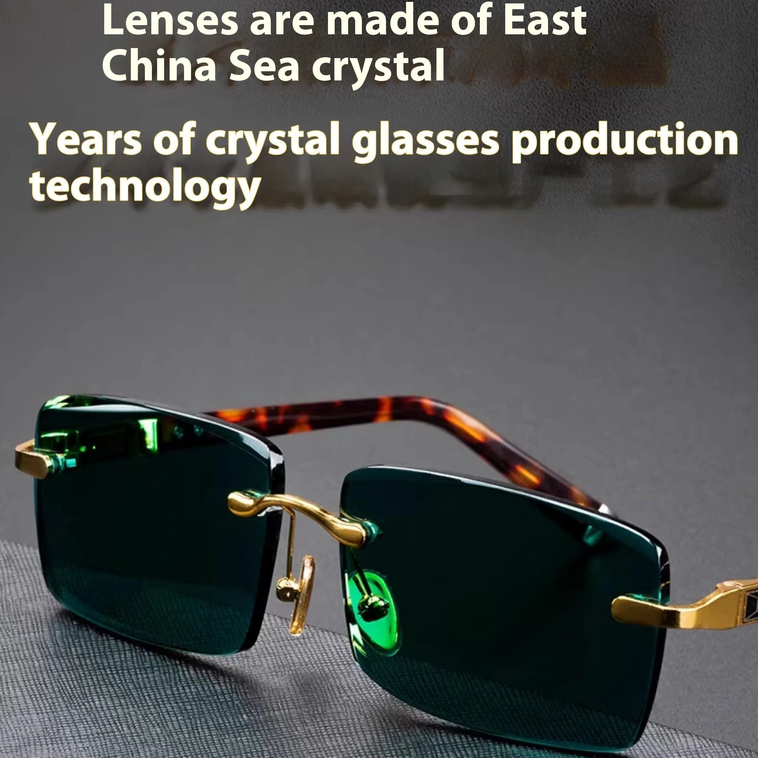 Dark green frameless crystal sunglasses with a distinctive design, shown with a hard case and lens cloth.