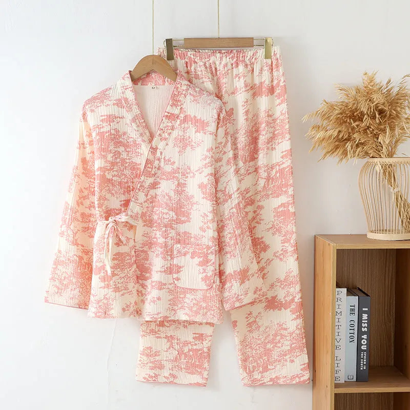 Women's pink cotton gauze lounge suit set with long sleeve top and trousers on a hanger.
