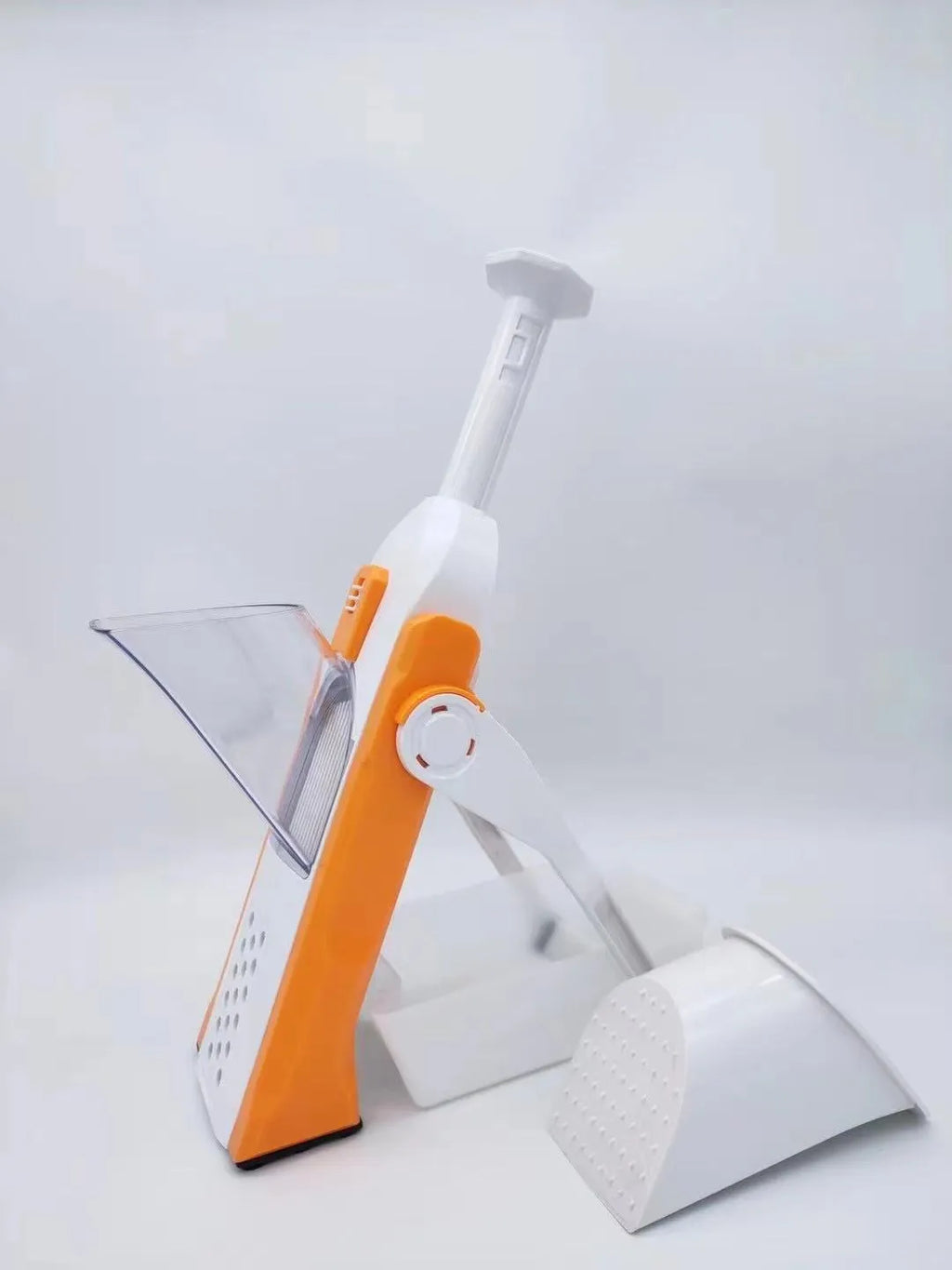 White and blue multifunctional vegetable slicer with stainless steel blade and cleaning brush on a kitchen counter