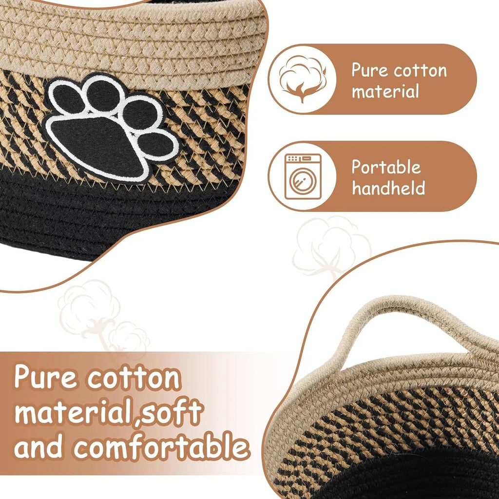 Small light beige woven cotton rope storage basket with handles on a wooden surface.