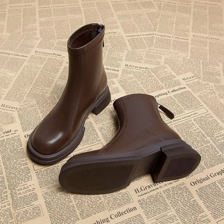 Women's black ankle boots with thick flat heel and back zipper, round toe design