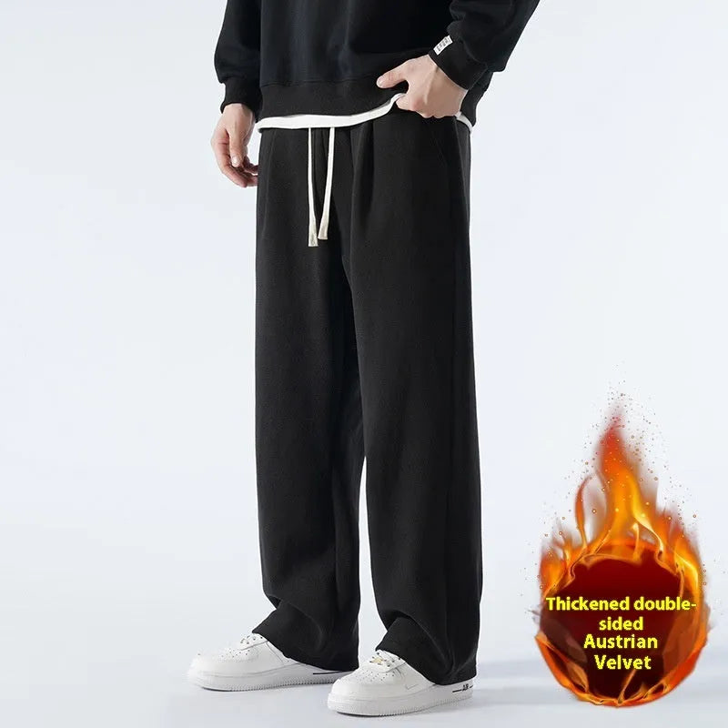 Men's apricot double-sided polar fleece winter trousers with a loose fit and drawstring waistband on a hanger.