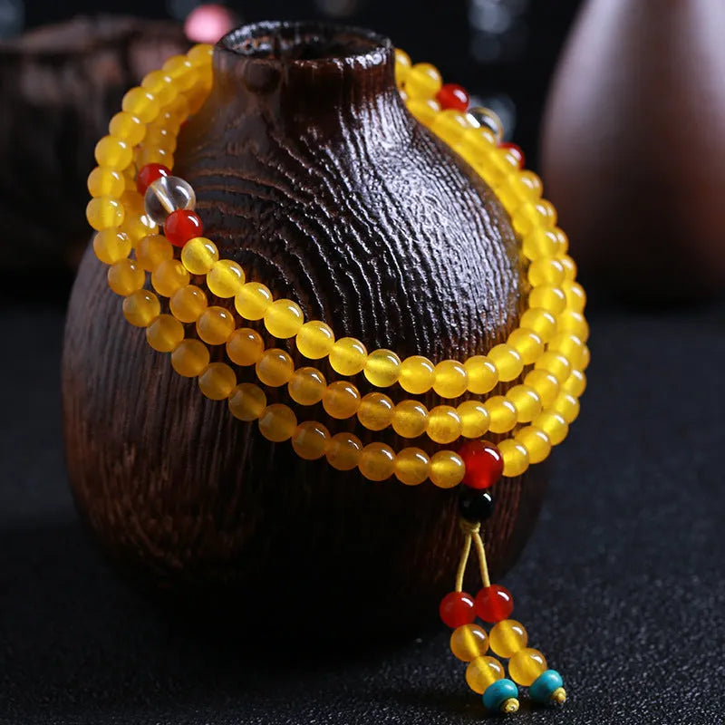 108-bead polished agate and crystal necklace with geometric beads and matching canary stone bracelet on display