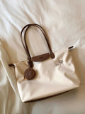 Pink Oxford cloth large tote shoulder bag with a structured square shape and a shoulder strap.