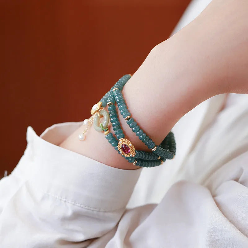 Blue water jade abacus beads bracelet with tourmaline and pearl three-ring design on wrist