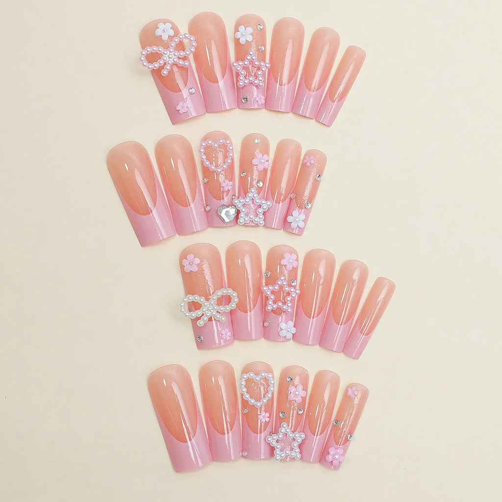 Super long false nails with a red love pattern, spot drill details, and a bow accent on a plastic armour suit.