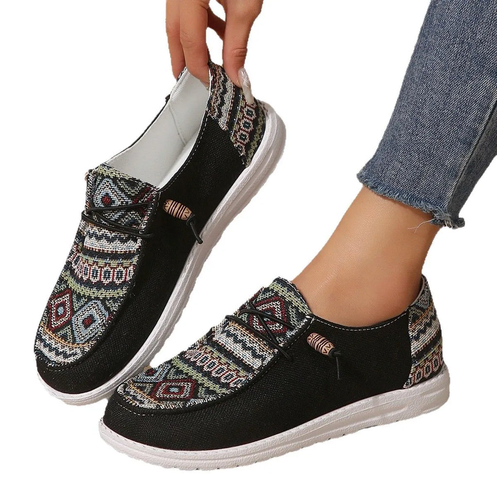 Women's black slip-on flat shoes with round toe and rubber sole