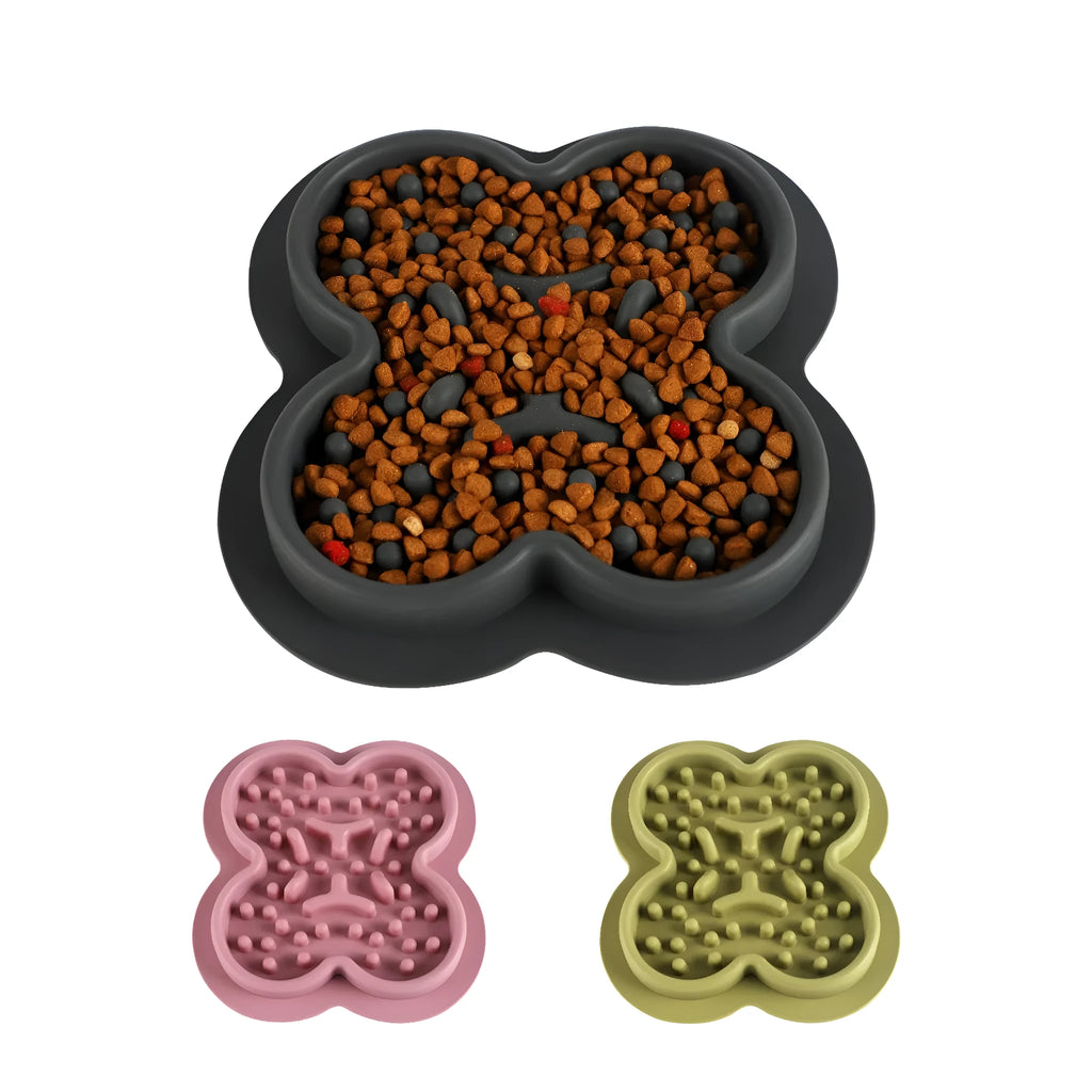 A blue silicone pet licking pad with a textured surface, placed on a wooden floor.