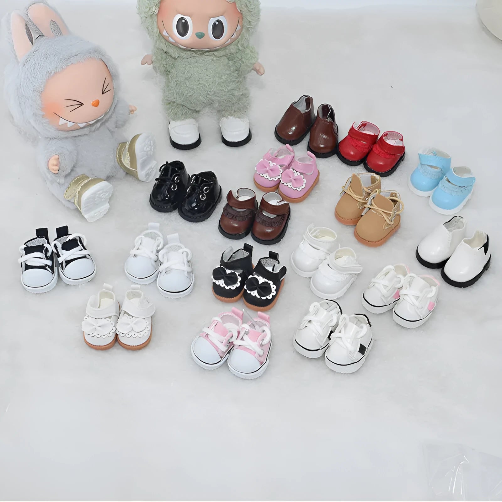 One pair of small black PU leather doll shoes for a 17cm high doll.
