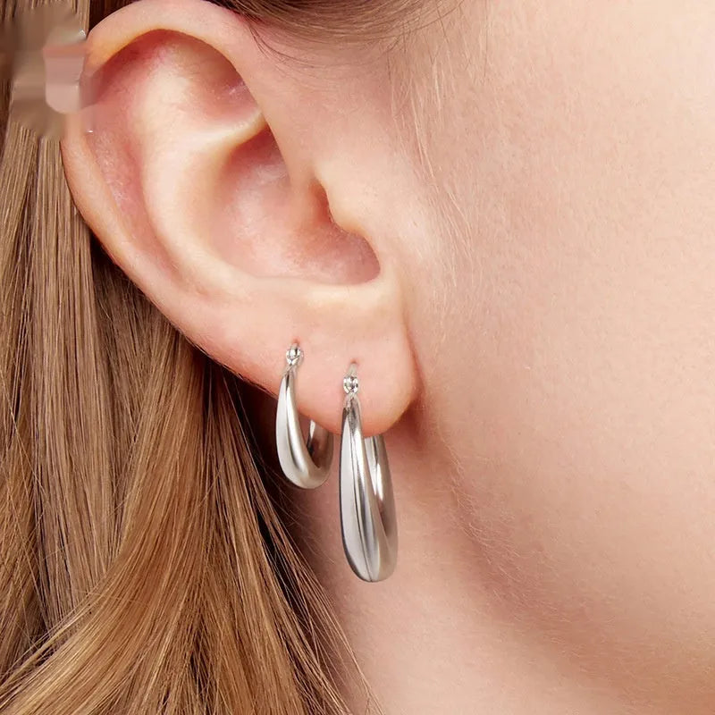 Geometric copper ear clip earrings with silver needle accents in classic ring design