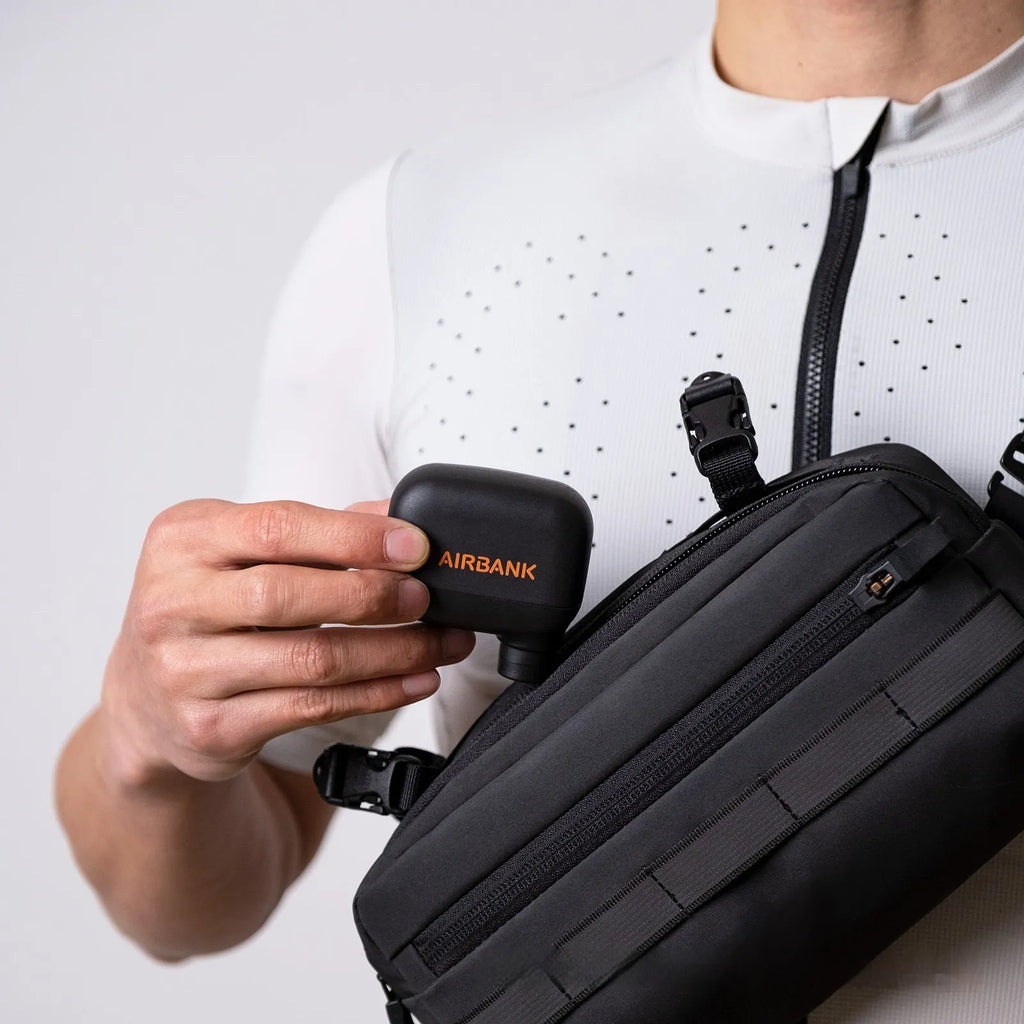 Black AS100 mini electric bicycle pump with USB charging cable and waterproof storage bag