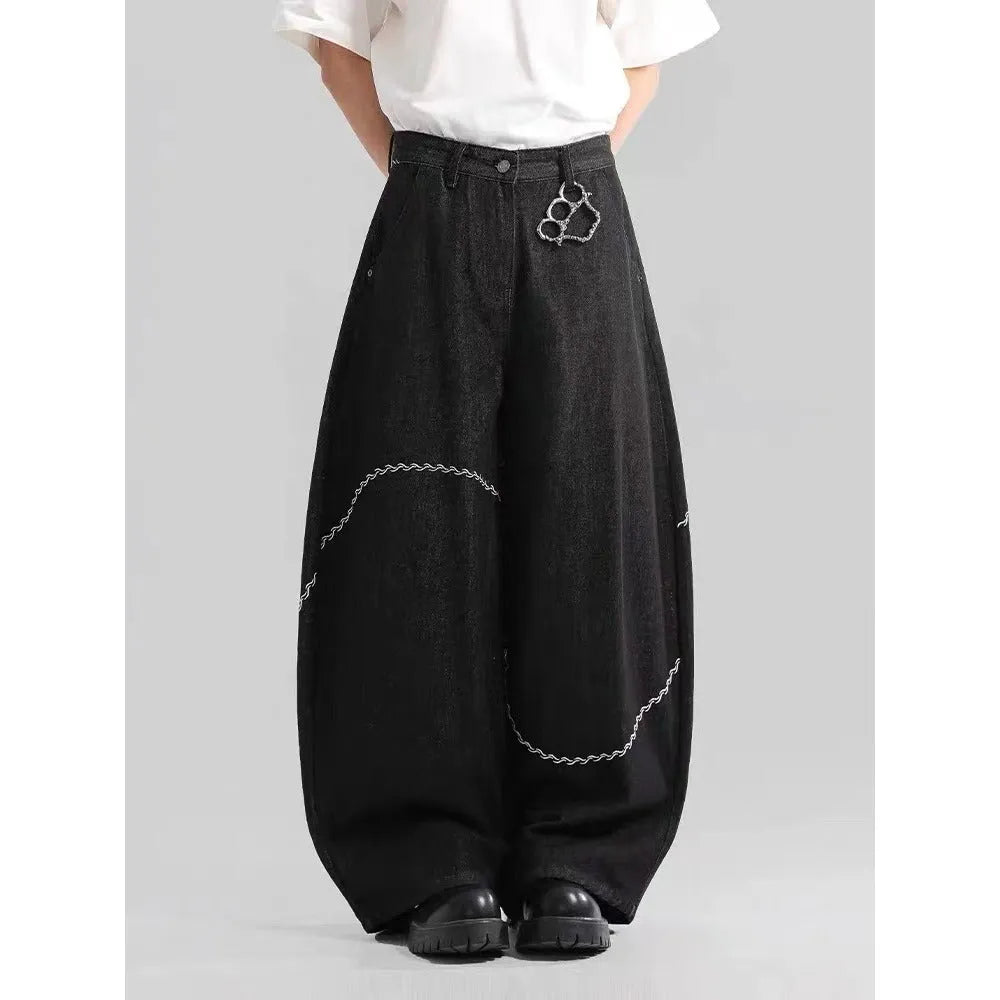 Black straight-leg denim trousers with mid waist and zip placket closure on hanger