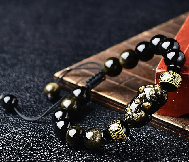 Natural obsidian Pi Xiu bracelet with hand-woven cord and golden sheen on black beads