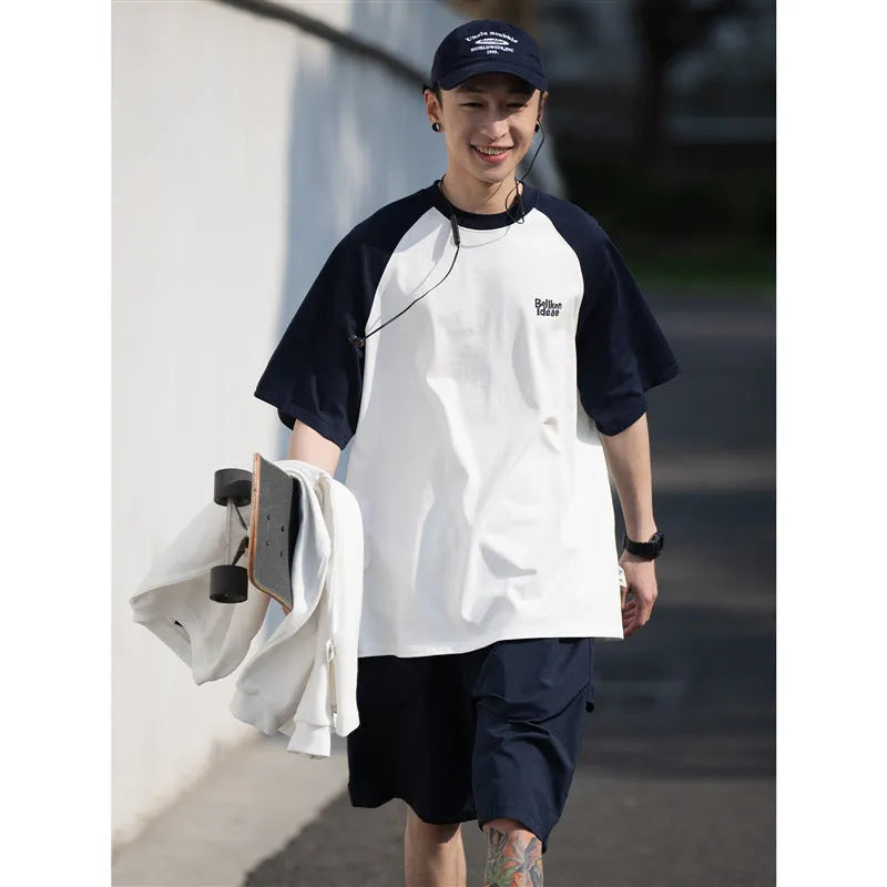 Blue loose-fit men's casual raglan sleeve T-shirt on a hanger.