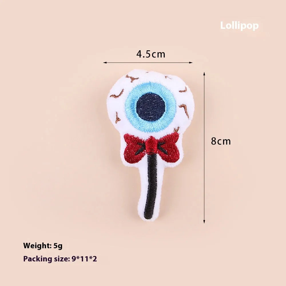 Small plush cat teaser wand with replaceable candy and skull head designs for interactive feline play