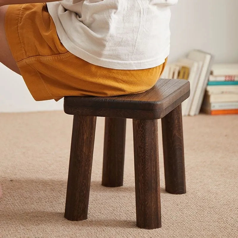 Solid wood distressed finish changing stool with bracket structure.