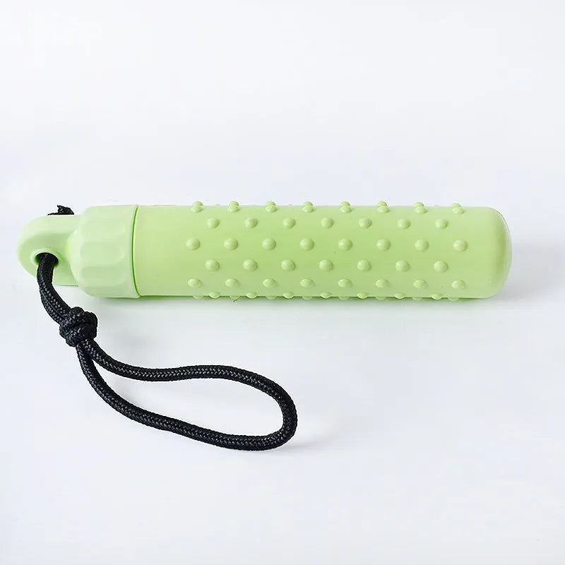 Floating dog pool toys in red and green TPR with rope, resting on water surface