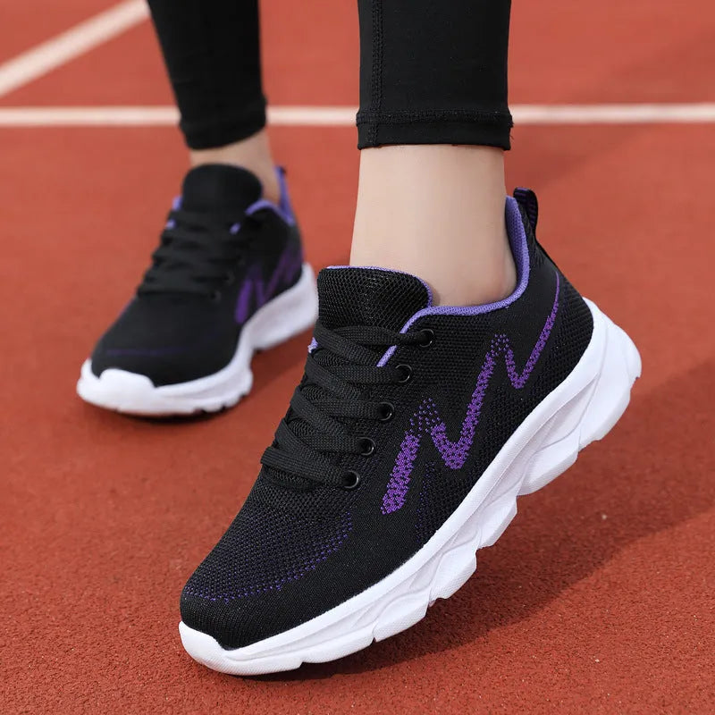 All black women's lightweight mesh sneakers with wedge heel and front lace-up design