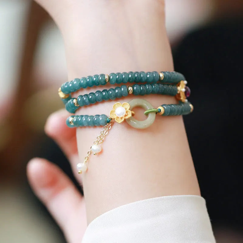 Blue water jade abacus beads bracelet with tourmaline and pearl three-ring design on wrist