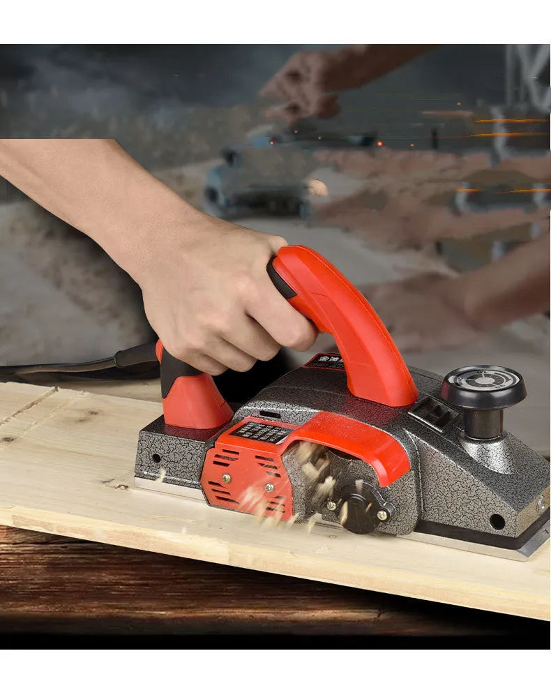 Red desktop electric wood planer with aluminium body showing 82mm planing width and power cord