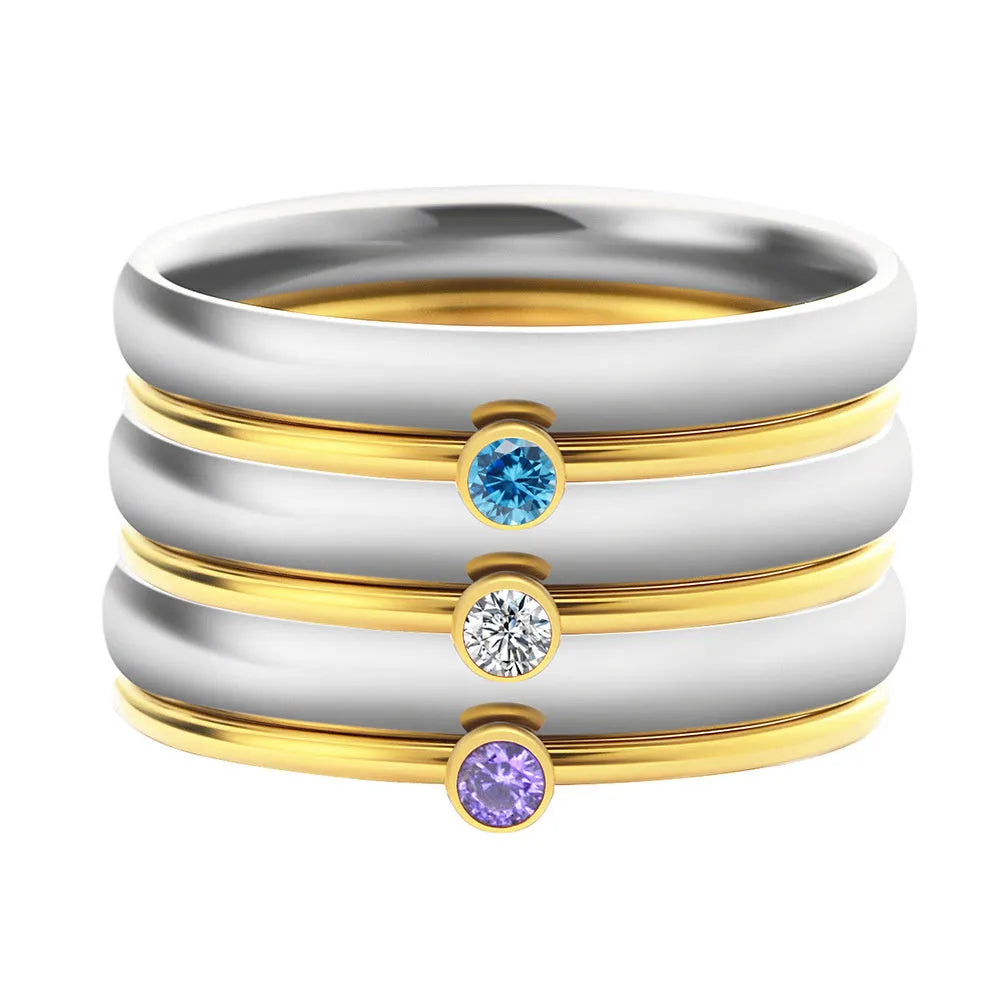 Gold geometric engraved titanium steel ring with a superimposed dark blue December birthstone.