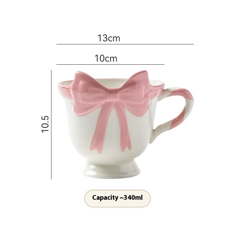 Ceramic mug with heart bow design in white powder or black pink colours, 301-400ml capacity