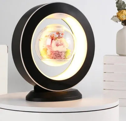Magnetic levitation heart lamp with preserved pink rose floating above a stable stand, LED night light, home decor