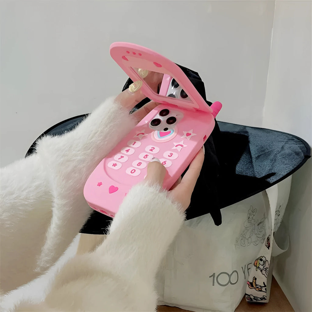 Light pink silicone flip phone case for iPhone with a built-in mirror on the front.