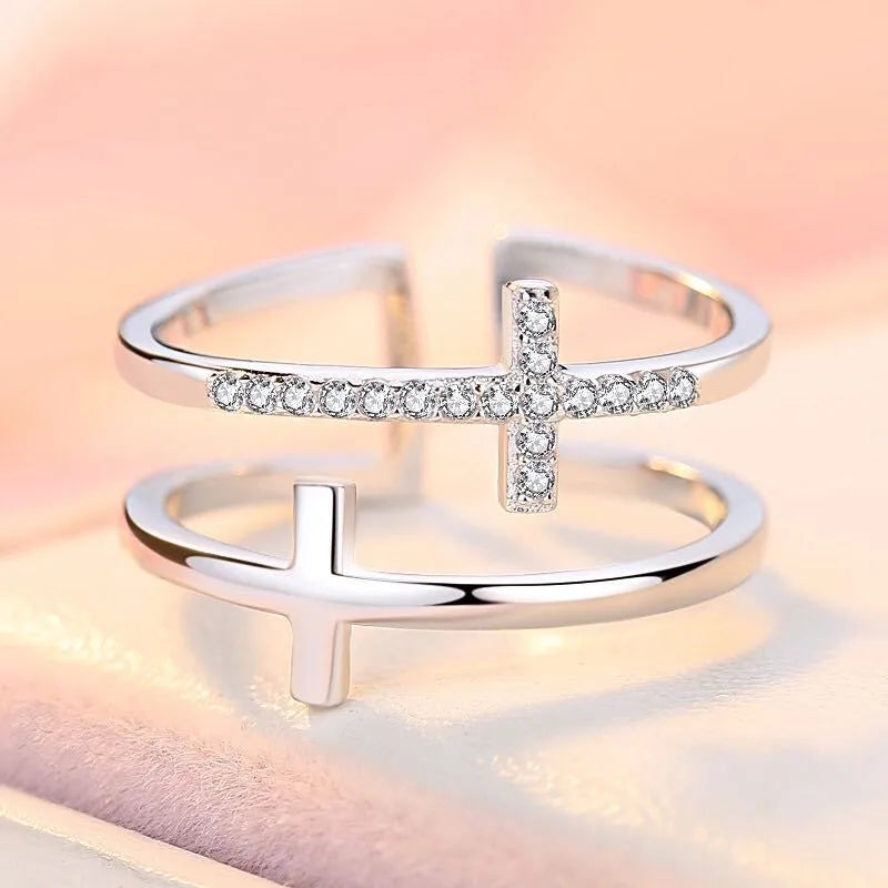Adjustable copper ring with double cross design, white gold electroplated finish, and zircon gemstones in sterling silver inlays