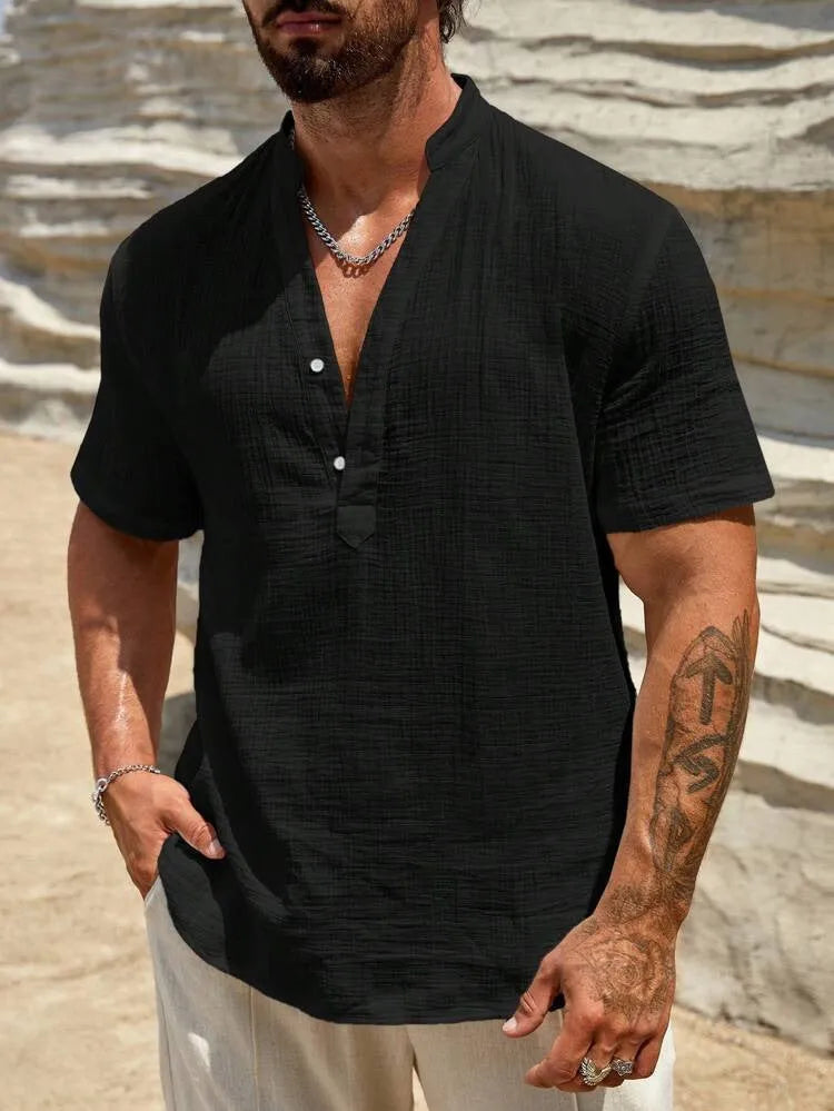 Men's solid colour stand collar short-sleeved shirt in a light blue shade, showing the slit detail and casual fit.