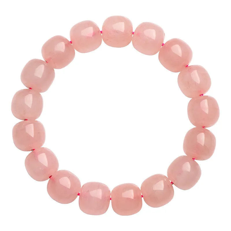 Pink natural crystal barrel bead bracelet with geometric shape on wrist.