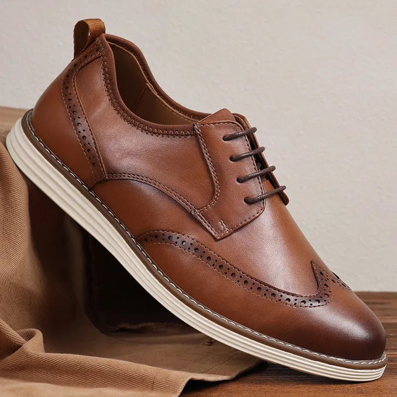 Men's black and brown slip-on business casual shoes with round toe and carved pattern detail