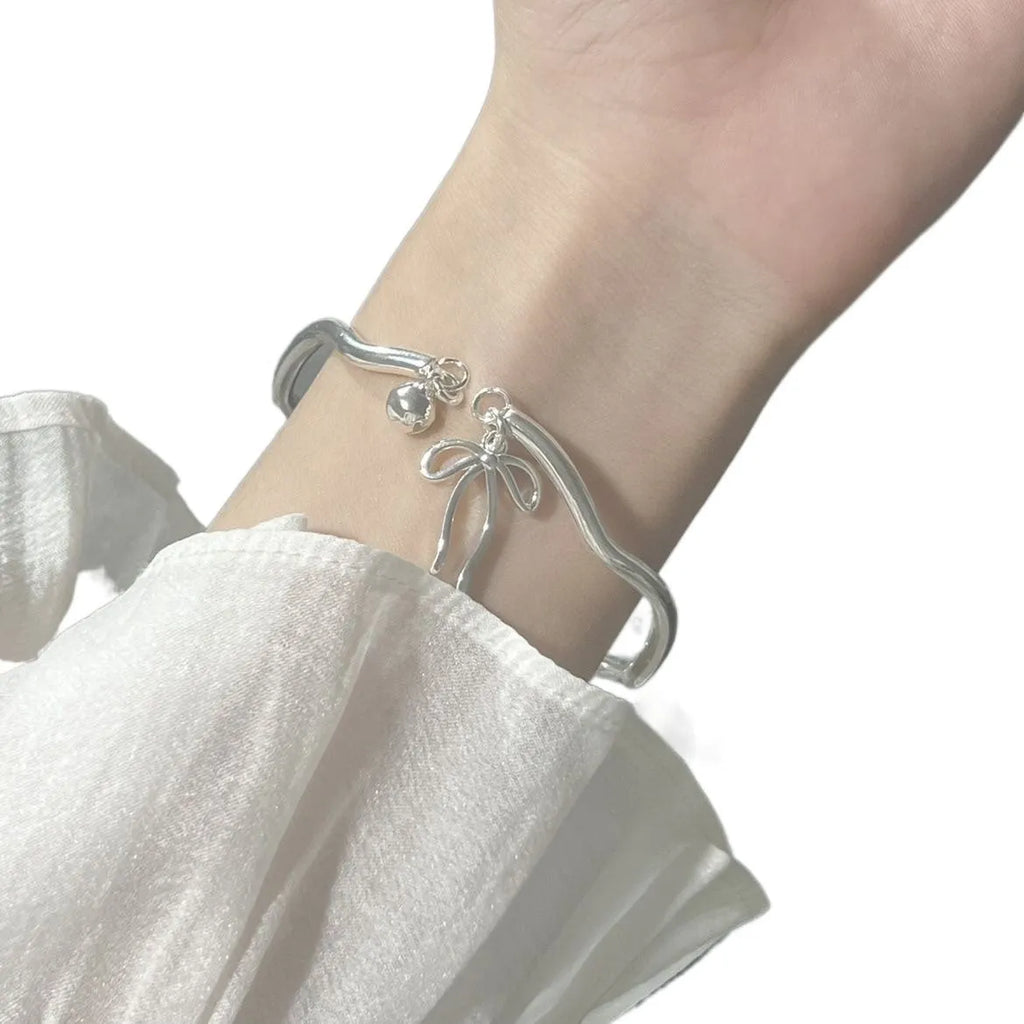 Silver adjustable bow bracelet with bowbell clasp on adjustable chain