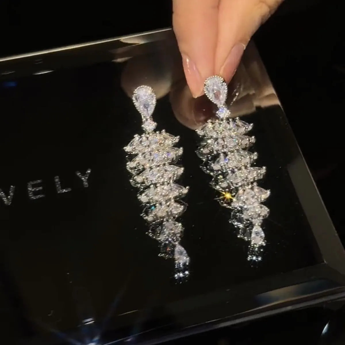Pair of silver-coloured Christmas tree drop earrings with pagoda shape on stud fastenings.