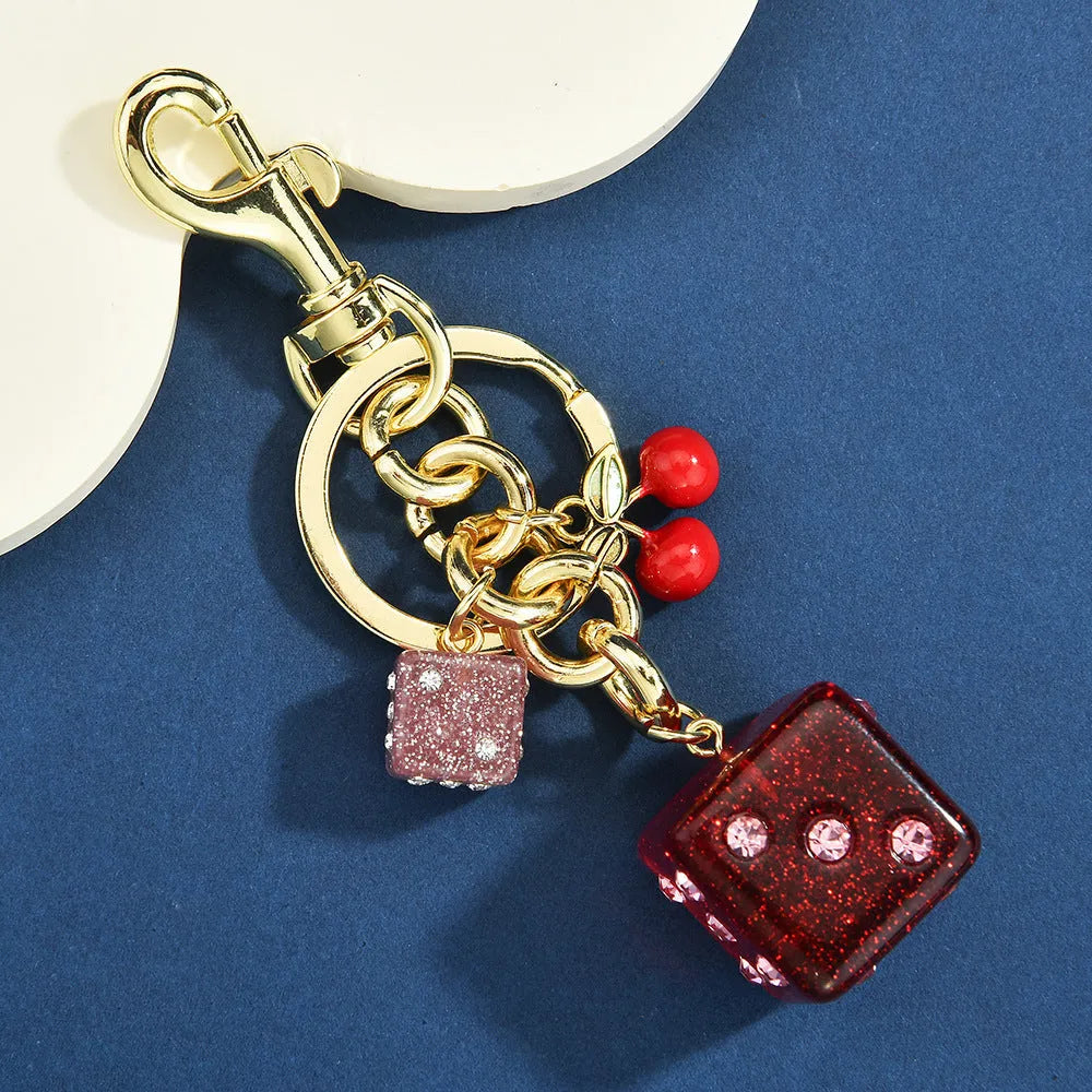 Square pattern metal keychain pendant with two-tone cherry dice design and electroplated finish