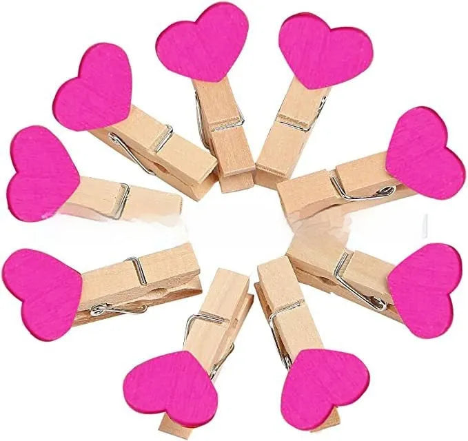 Five solid wood heart-shaped clips in red colour arranged together