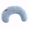 Small half-donut shaped pet pillow in blue faux fur, showing quilted texture and plush filling.