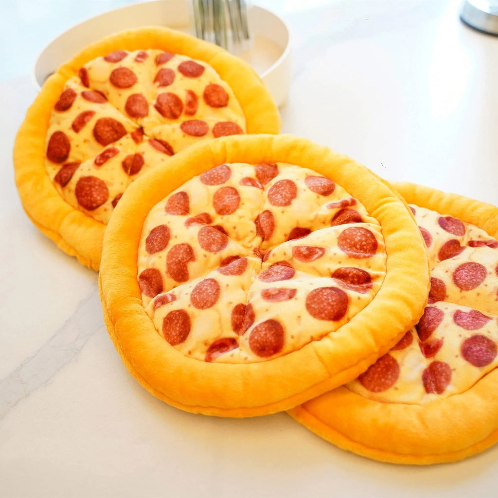 Yellow plush pizza-shaped dog toy with a squeaker inside for chewing and interactive play.
