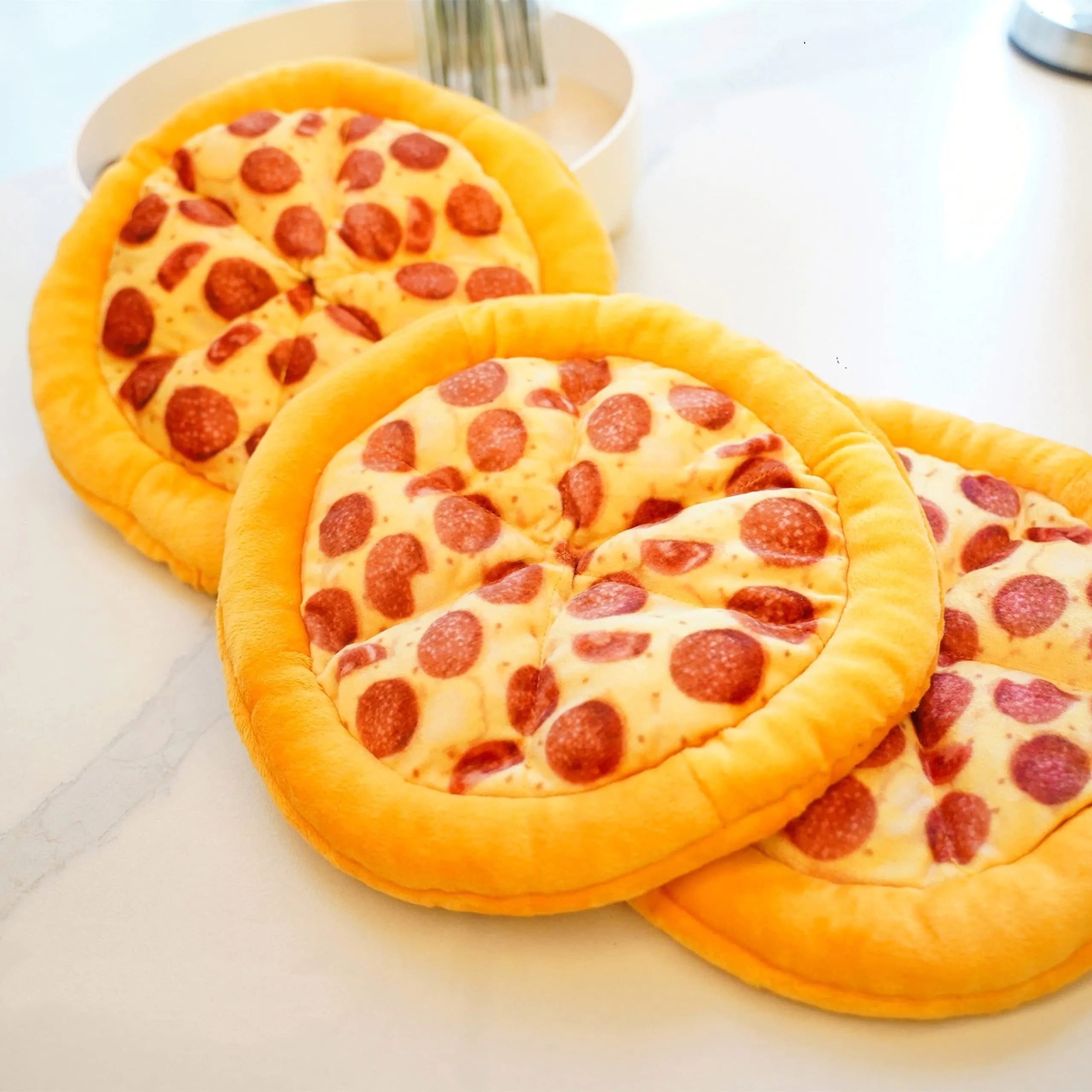 Yellow plush pizza-shaped dog toy with a squeaker inside for chewing and interactive play.